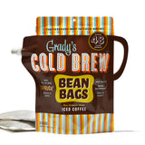 Grady’s Cold Brew Bean Bags in the all-in-one “Spouch” format. The brown pouch with a built-in handle and pour spout features colorful stripes on the top and bottom. Text on the packaging highlights that it makes 48 fluid ounces, includes two bags, and is brewed overnight with added water. Two bean bags are shown beside the pouch.