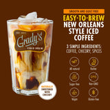 Tall glass of Grady's Cold Brew iced coffee with cream swirling through the coffee and ice cubes visible at the top. Text highlights New Orleans-style iced coffee made with three simple ingredients: coffee, chicory, and spices. Product benefits shown include all-natural, kosher, sugar-free, non-GMO, vegan, and gluten-free. A callout notes the coffee is naturally sweetened with chicory. Brown background with Grady's Cold Brew branding and product information.