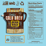 Grady's Cold Brew Decaf New Orleans Style Bean Bags package displayed with nutrition facts and ingredient information on a light blue background. The package makes 48 fluid ounces of New Orleans-style iced coffee and features Grady's colorful striped branding. Icons indicate Non-GMO Project Verified, Made in NYC, Kosher Parve, and recyclable packaging. Nutrition facts show 10 calories per 12-fluid-ounce serving, with four servings per container. Ingredients include coffee, chicory, and spices. A callout exp